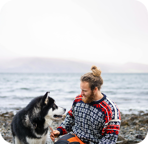a male team member sits with a dog