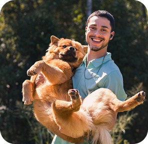 a male team member holds a dog
